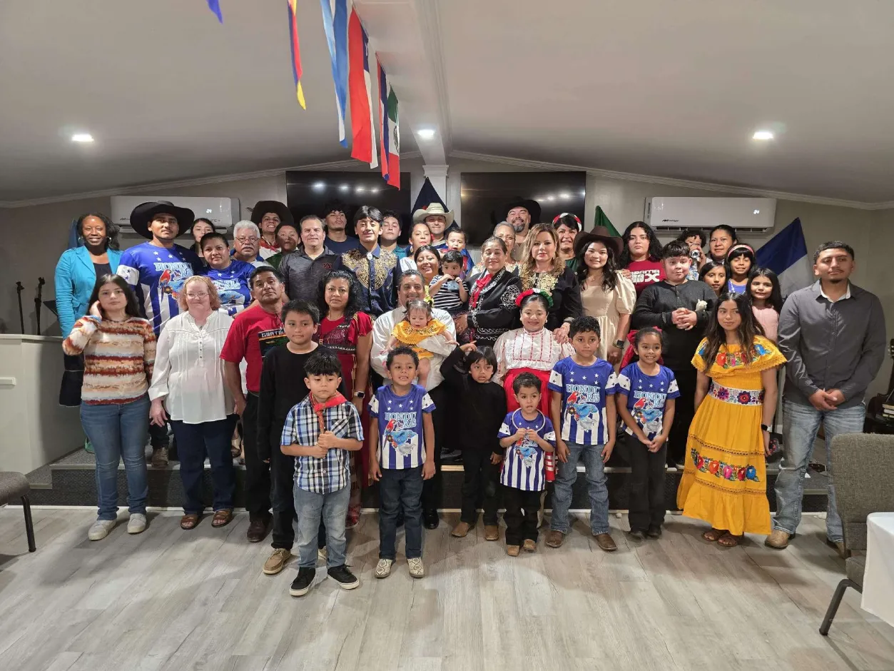 Church members with Latin American flags celebrating together